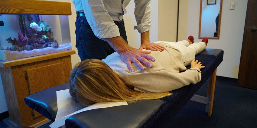San Francisco chiropractor at Shapero Chiropractic adjusting patient's shoulder to relieve pain
